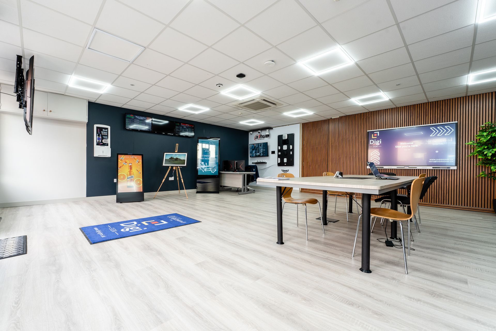 Digi Sign NI showroom with commercial screens, demonstration displays and a meeting table
